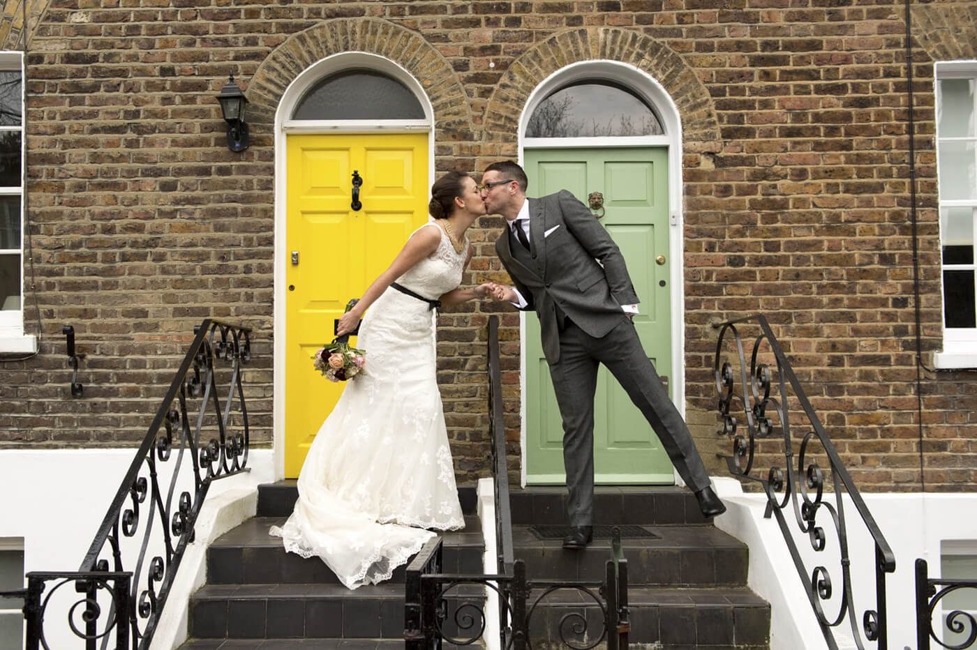 wedding couple on stairs kissing