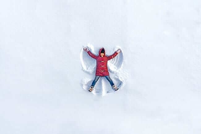 child making snow angel