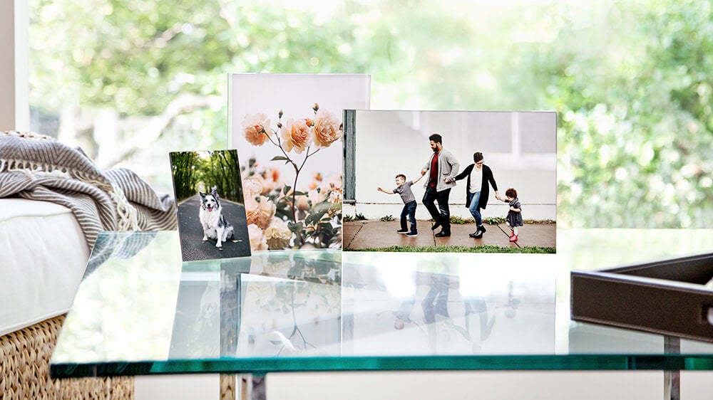 three acrylic prints on a table manufactured by printique