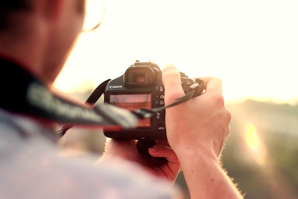 A man uses a camera.