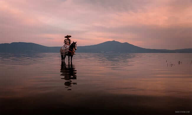 Mexican Cowgirl Riding Her Dancing Horse on Lake Chapala, Mexico