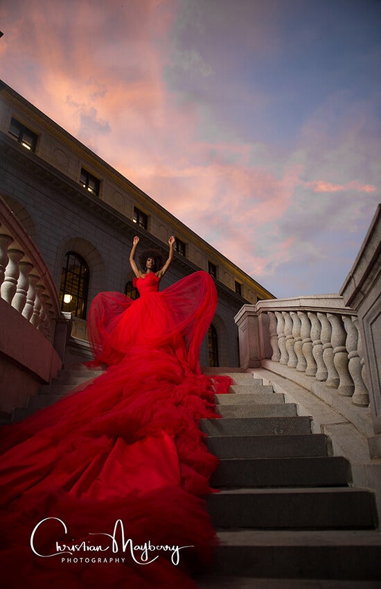 model with red dress on staircase