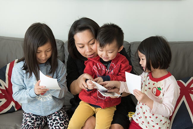 young family looking at pictures from Printique