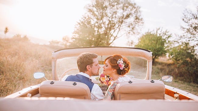 bride and groom in car