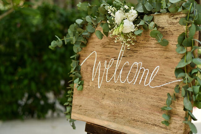 wooden welcome sign at wedding