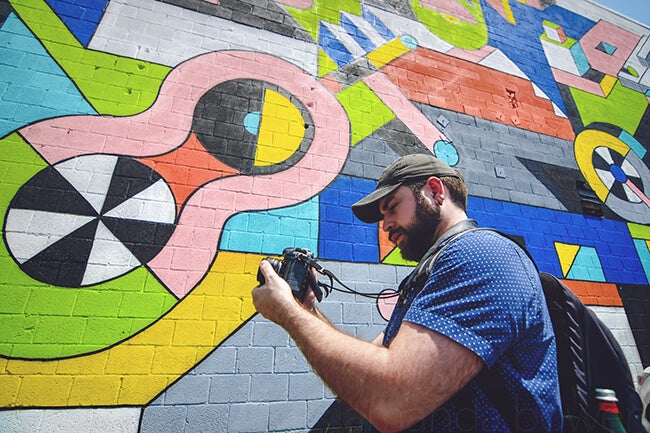 man in front of colorful wall