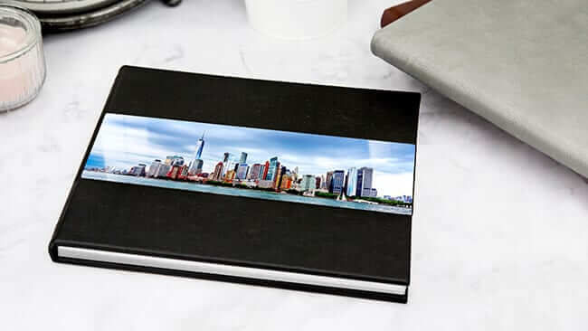 metal cover photo book with skyline on front produced by Printique