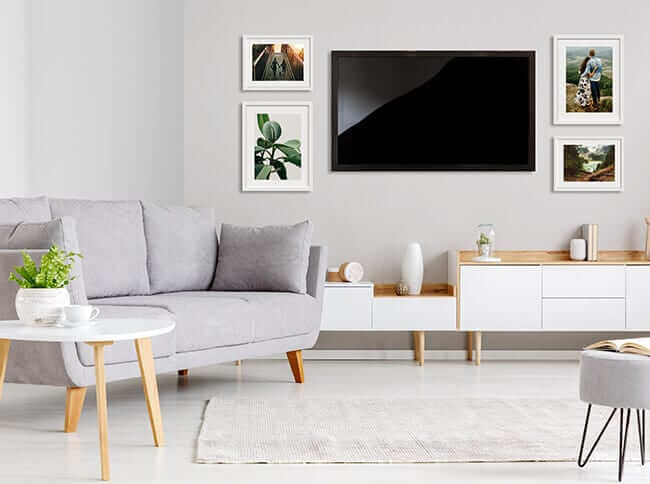 living room wall gallery with television and framed prints by printique
