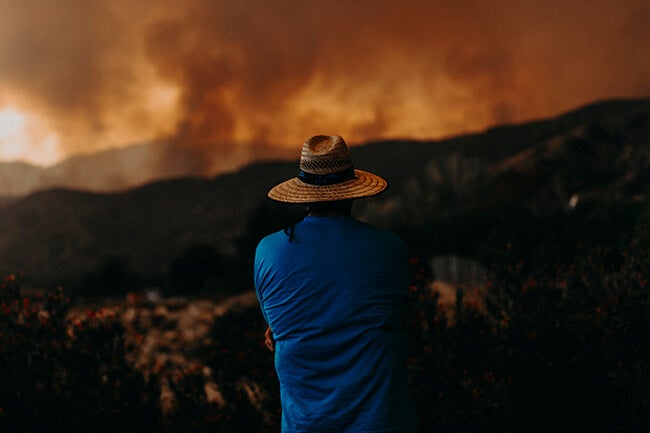 man looking at california wildfires