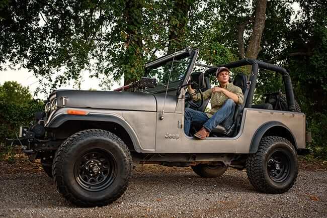 high school senior boy posing in truck