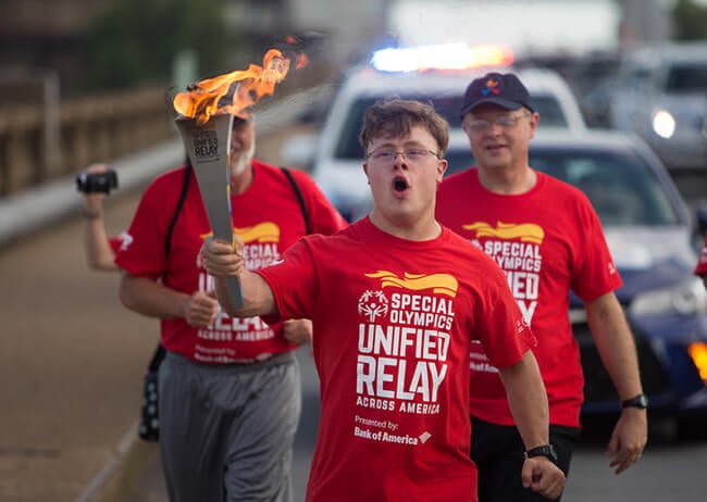 special olympian carrying torch