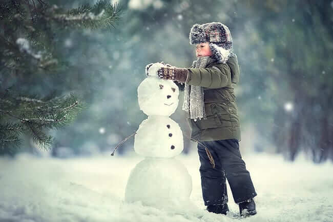 child building snowman