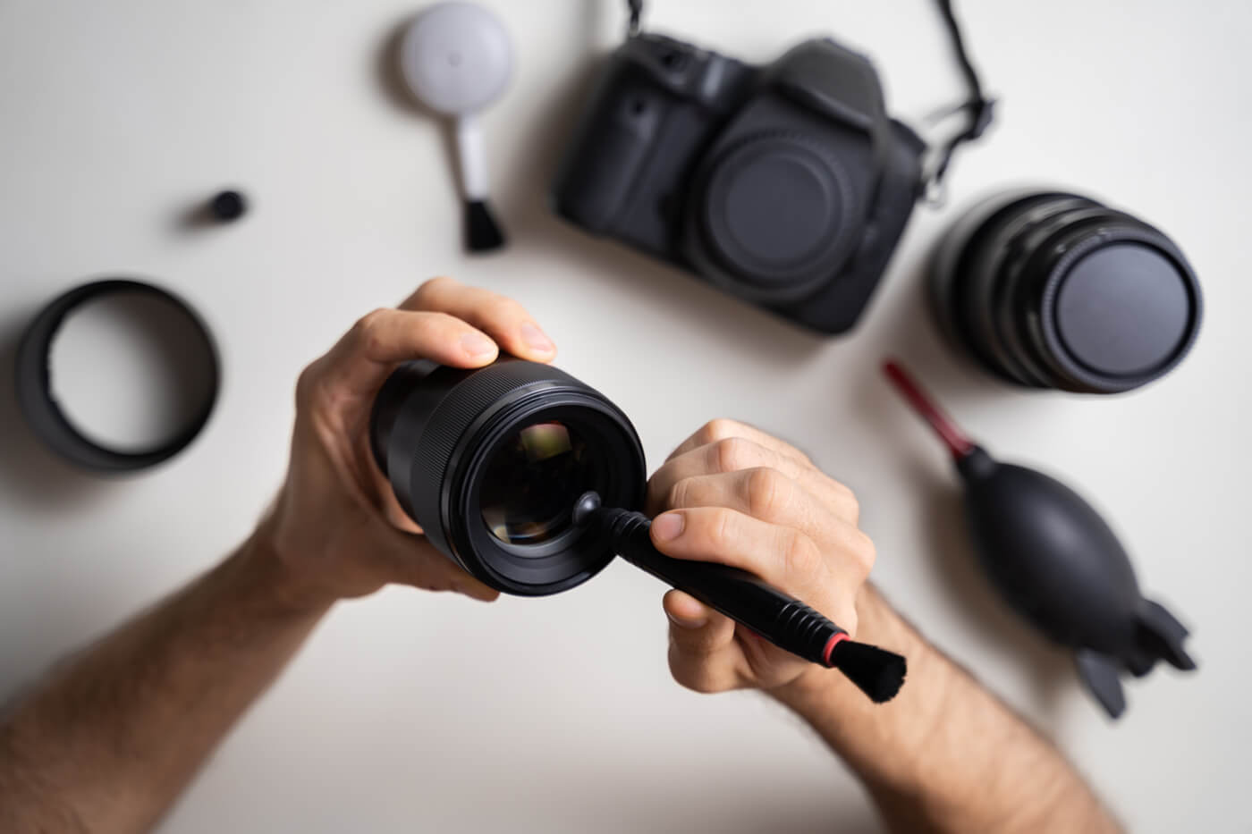 photographer cleaning lens