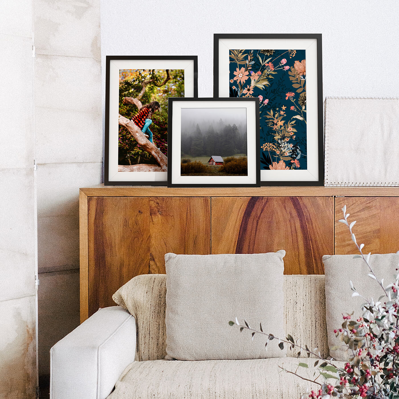 framed photos by printique on a buffet in front of couch