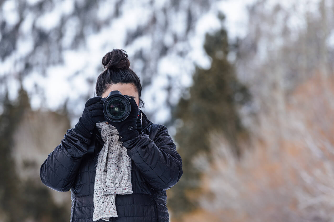 woman with camera in snow