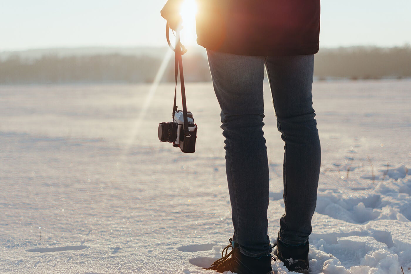 person in snow with camera