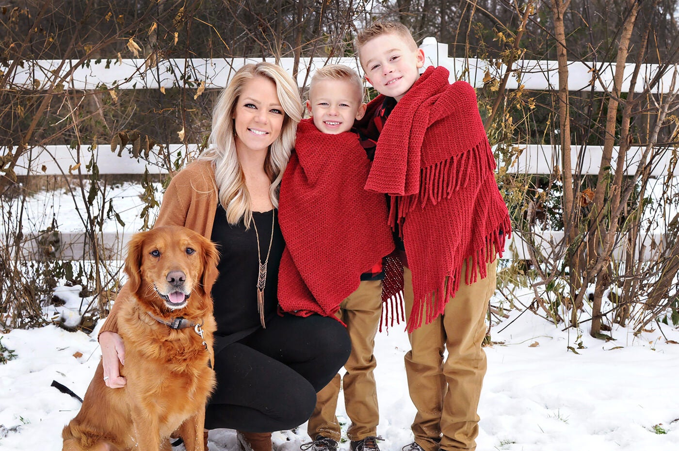 family in snow with dog portraits