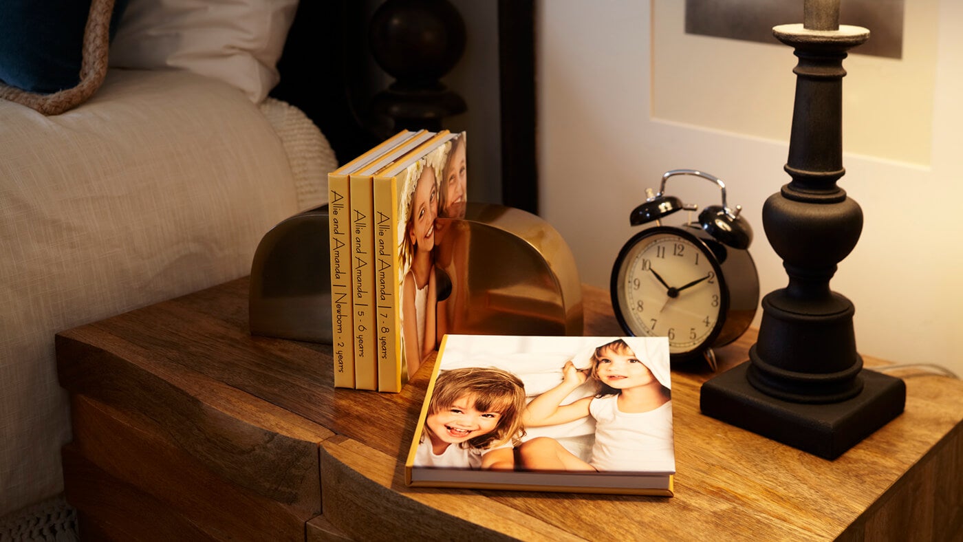 family photo books by printique on nightstand