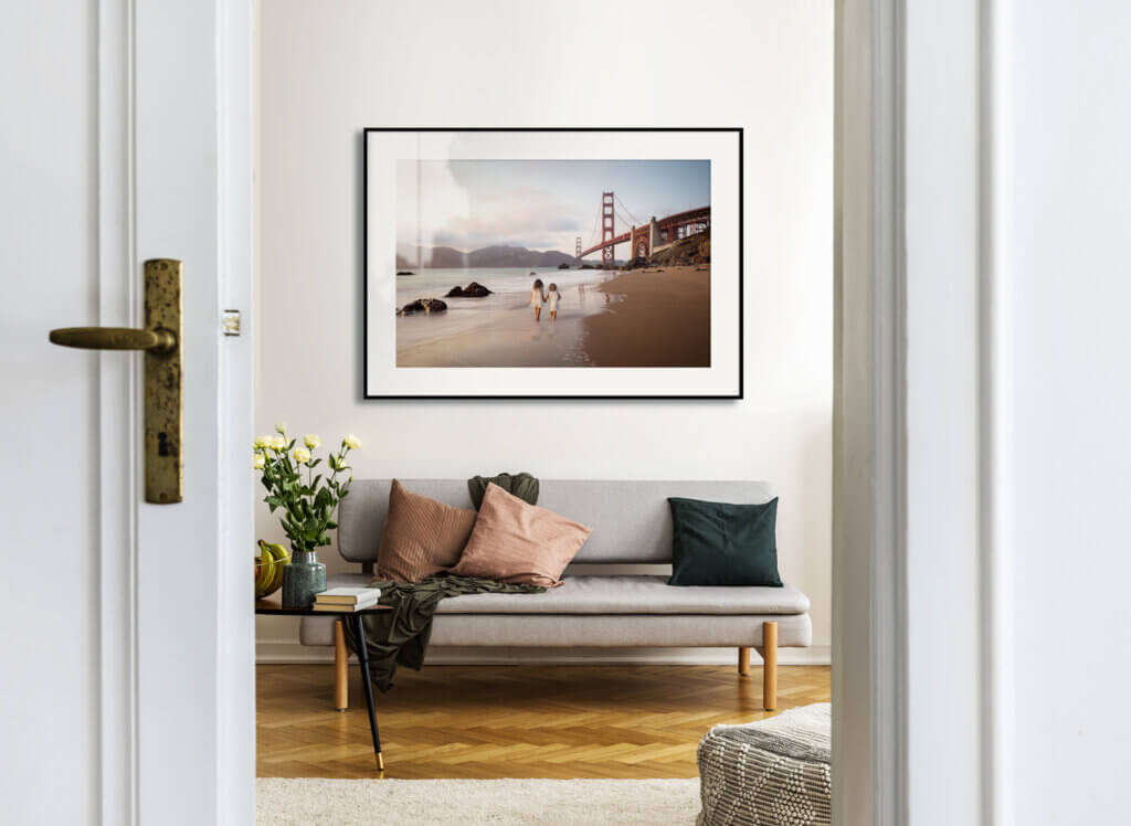 Gallery of poster on white wall of stylish living room interior with grey couch and pillows.