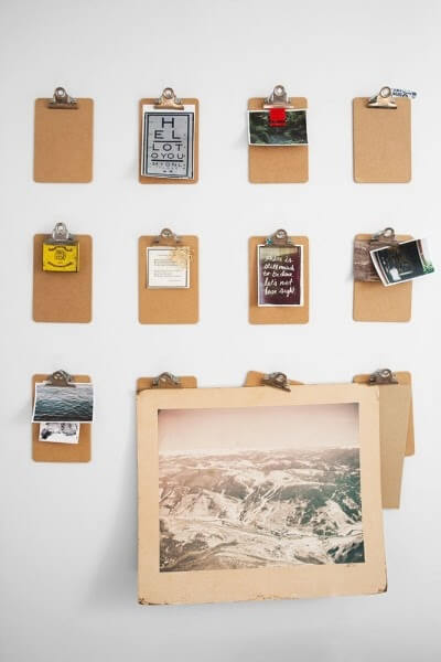 Using clipboards to hang photographs in your dorm room is a great dorm decor idea.