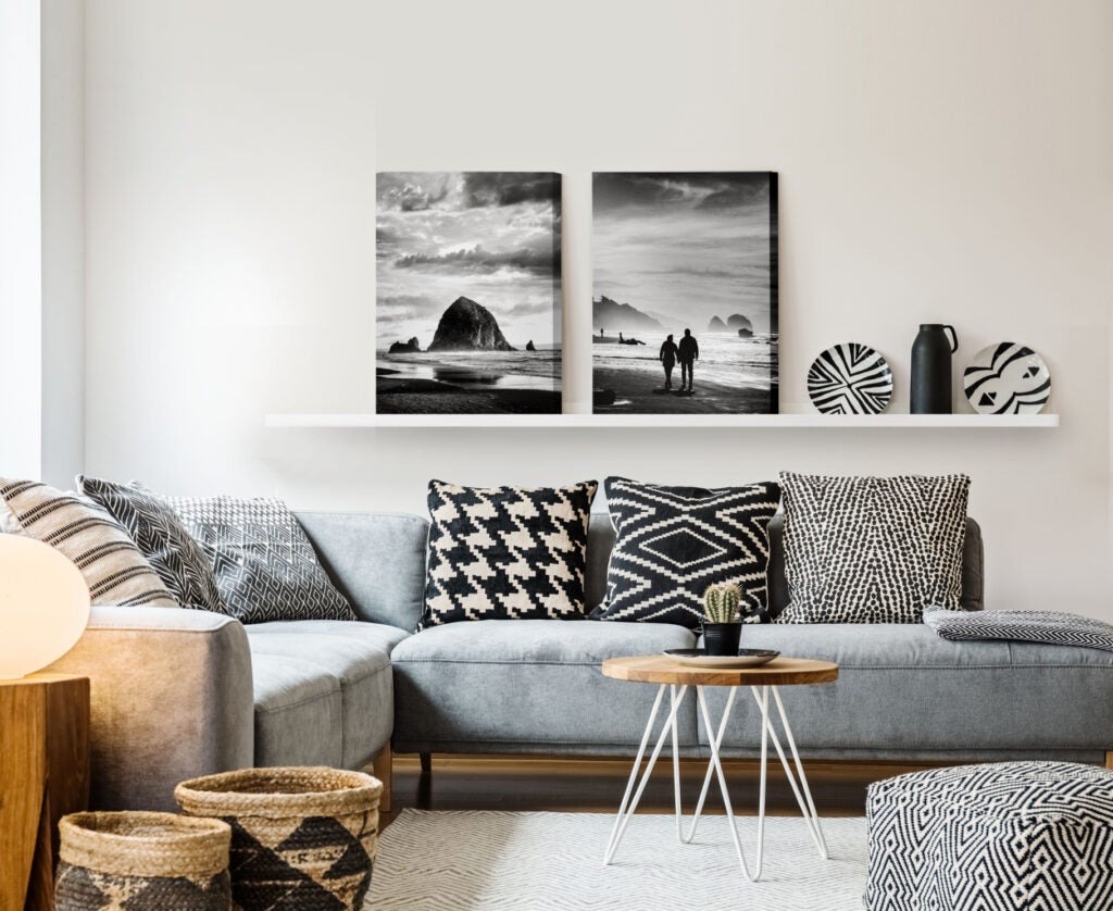 Black and white canvas prints as decoration on a living room mantle.