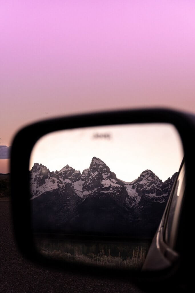 Mountains photographed in the rearview mirror.