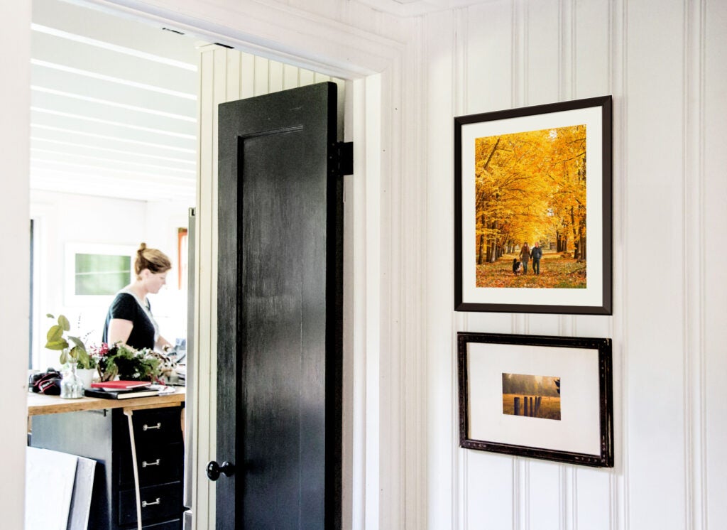 Home decorated with colorful fall prints in antique frames.