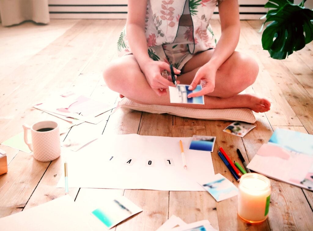 Girl creates vision board using photo prints.