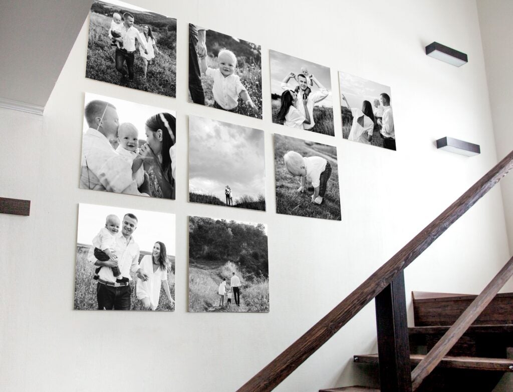 This black and white wall gallery of family photos is a great example of a personalized photo gift idea.