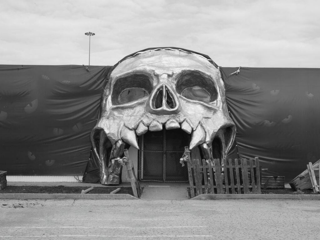 Haunted house entrance creepy skull Halloween decoration.