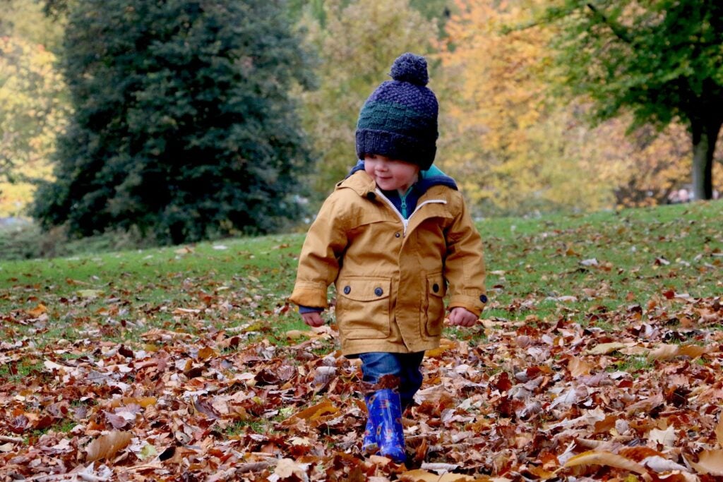 Little kid explores outside for holiday card photoshoot.