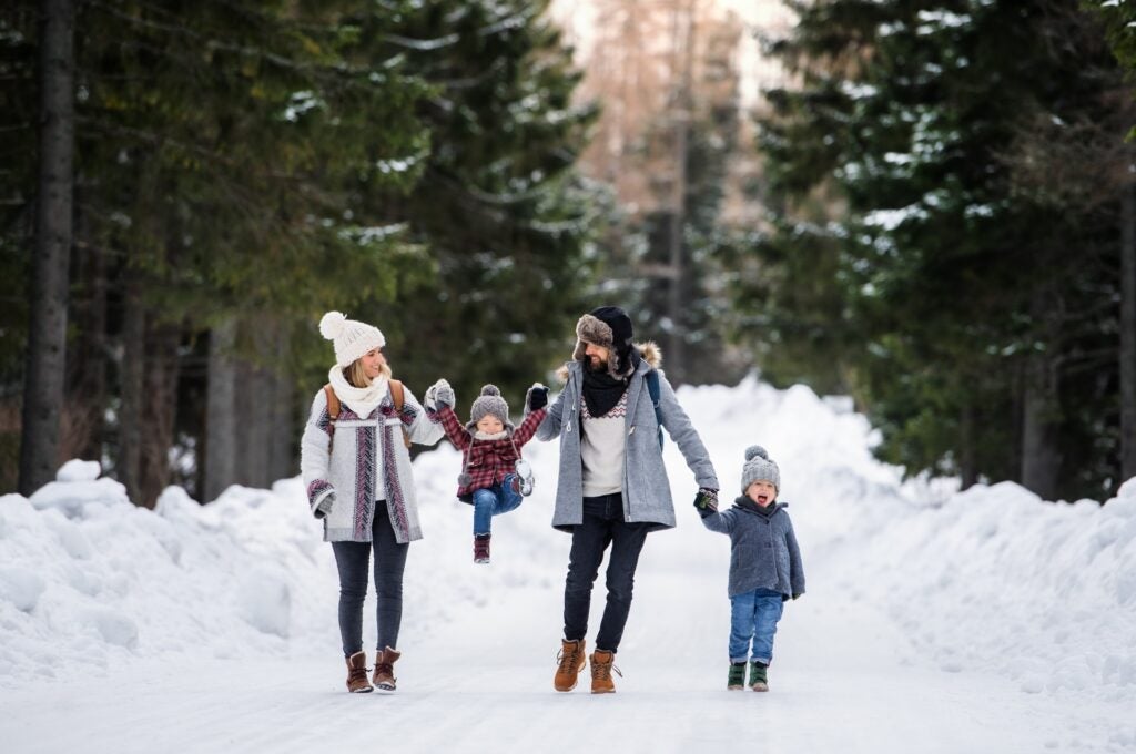 Family heads outside to find the perfect location for a Christmas card photo.