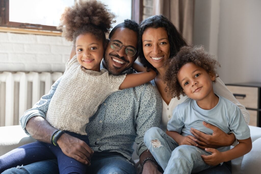 Family poses happily for holiday photo card picture.