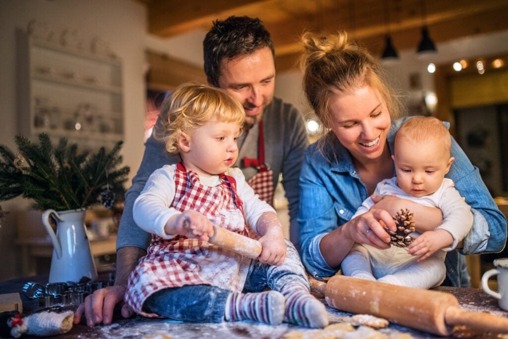 Family bakes together for holiday card picture.