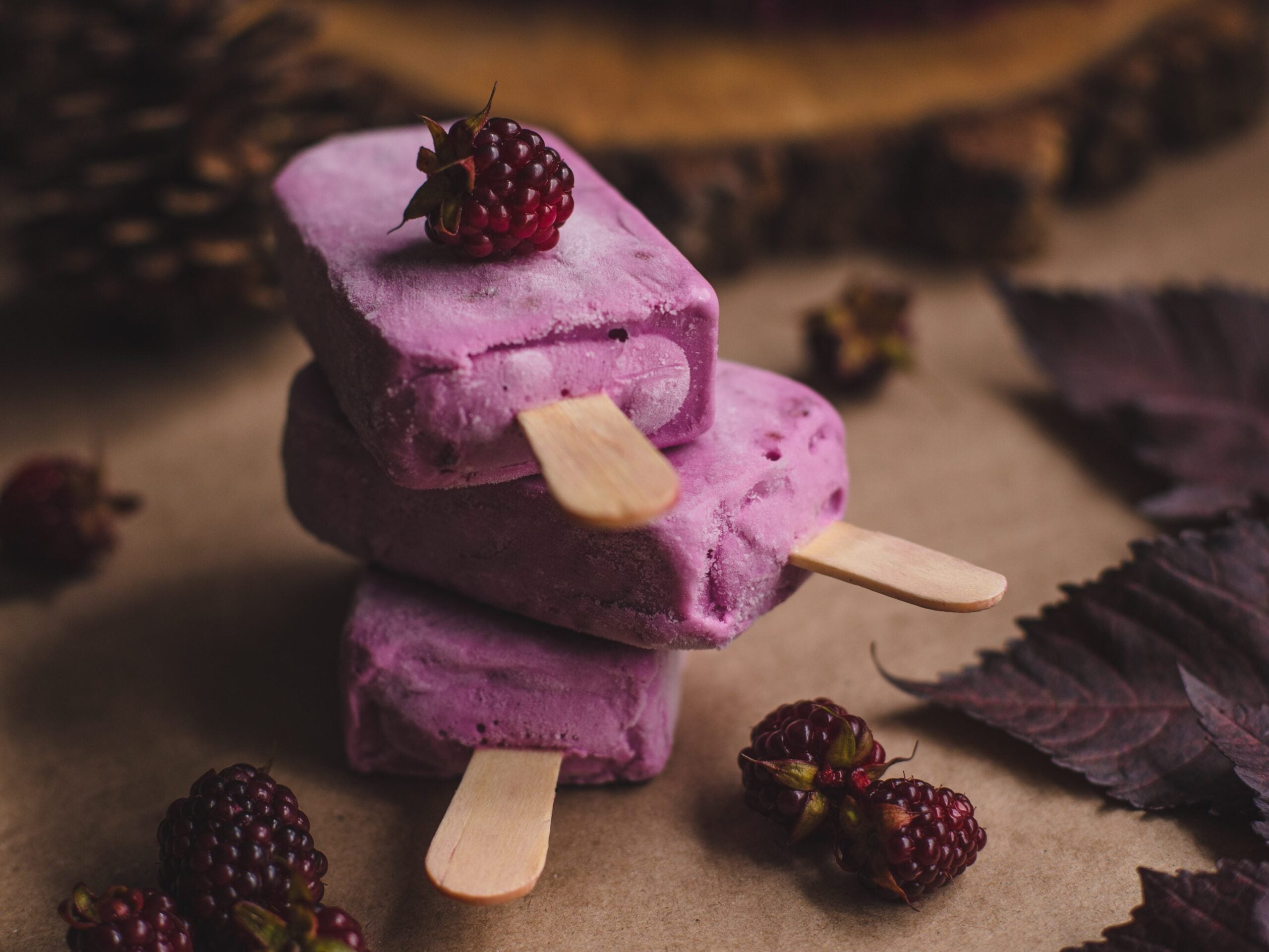 Raspberry purple popsicles serve as a great example of how angling your food photography the right way can make your food creations look even better than they taste.