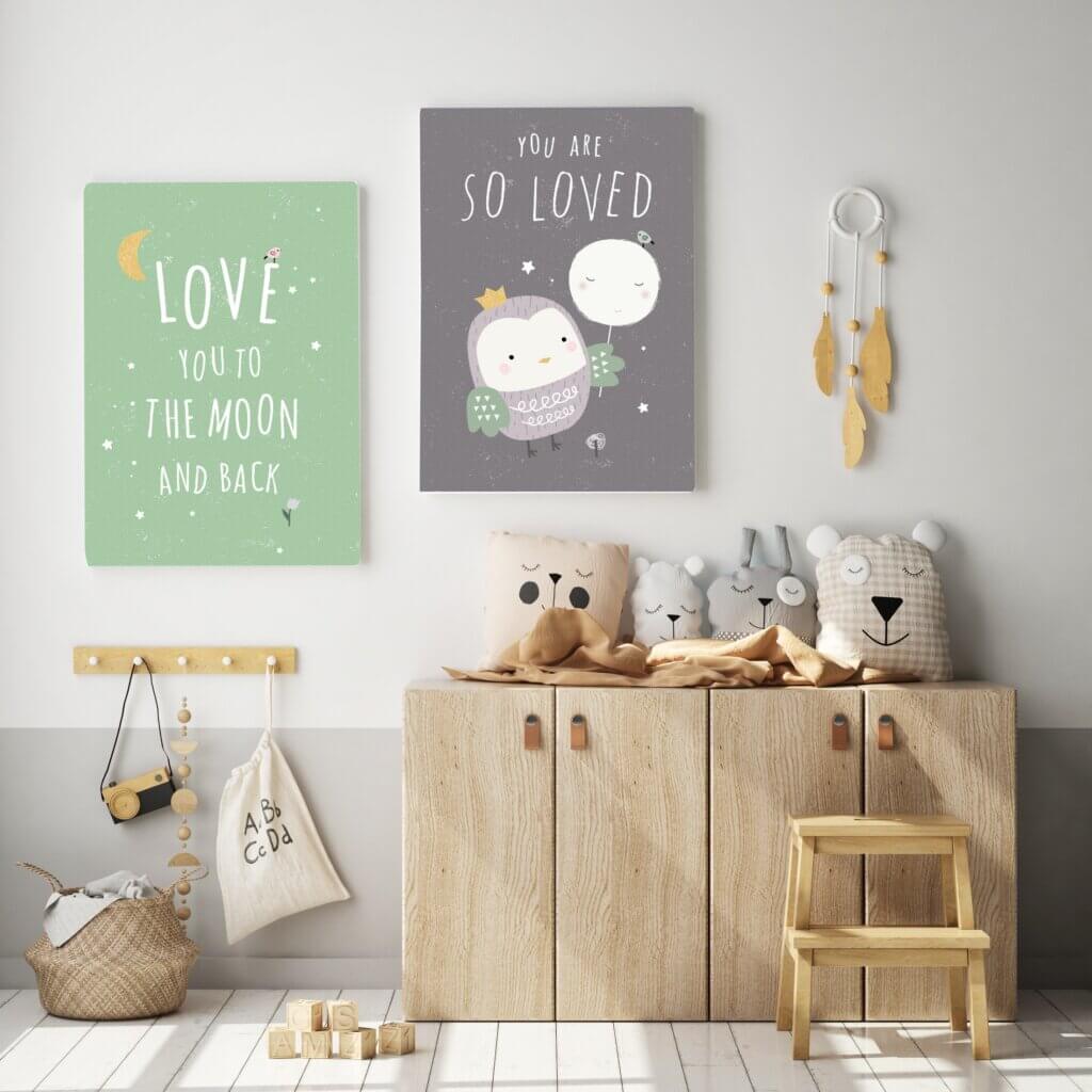 Happy quotes printed on canvas prints decorate a nursery wall.