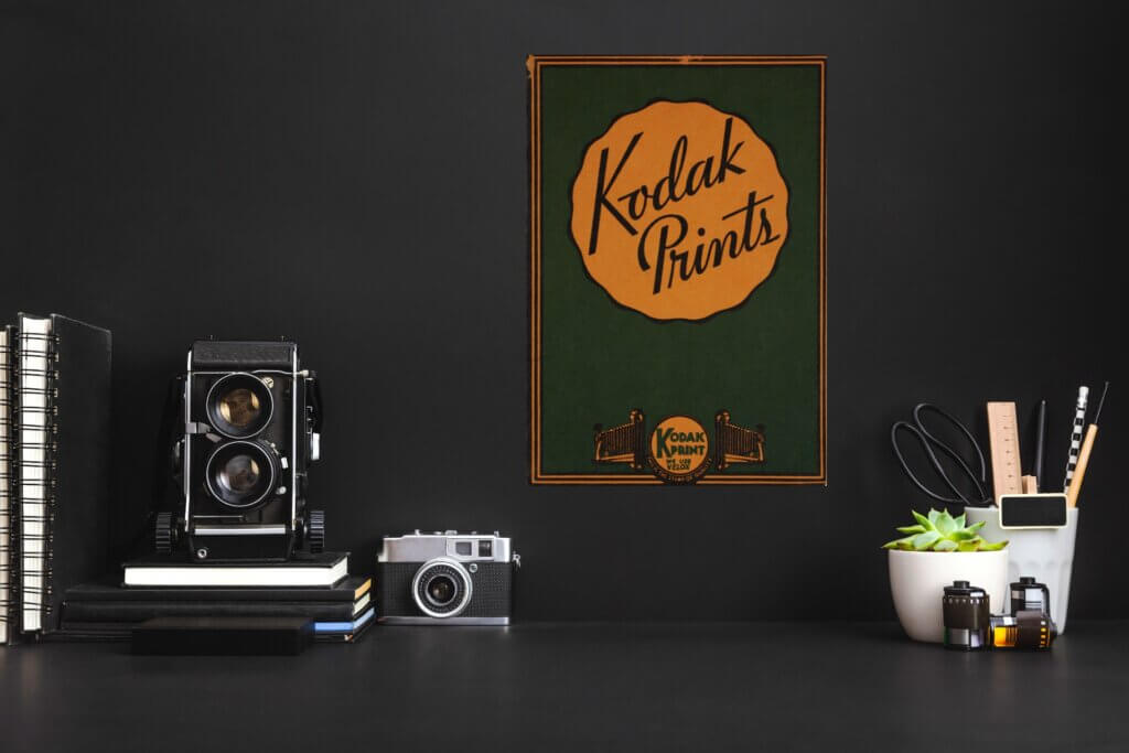 A vintage kodak free printable hangs on the wall in an office space, adding character and color to an otherwise dark, subdued room.