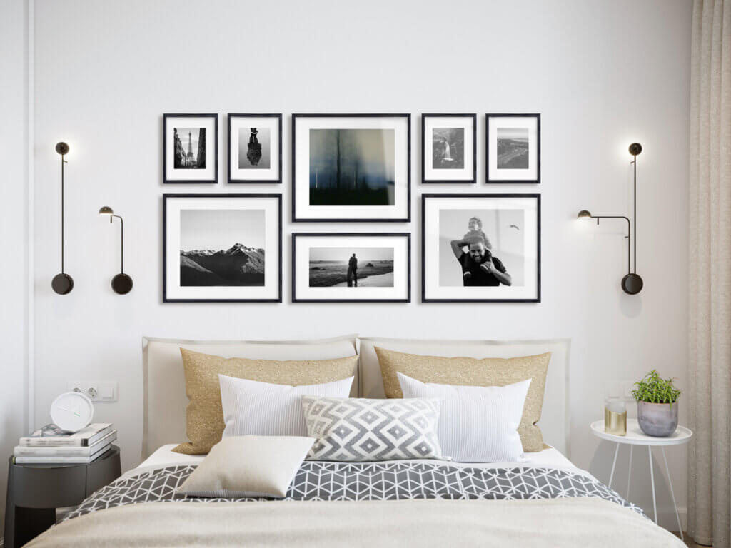 Black and white photos in a chic gallery for decorating above the bed.