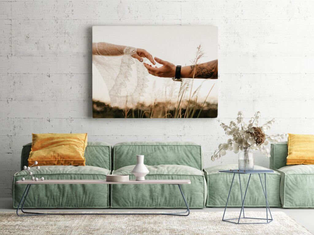 An intimate moment of hand holding between newly-weds is displayed on wedding canvas prints.
