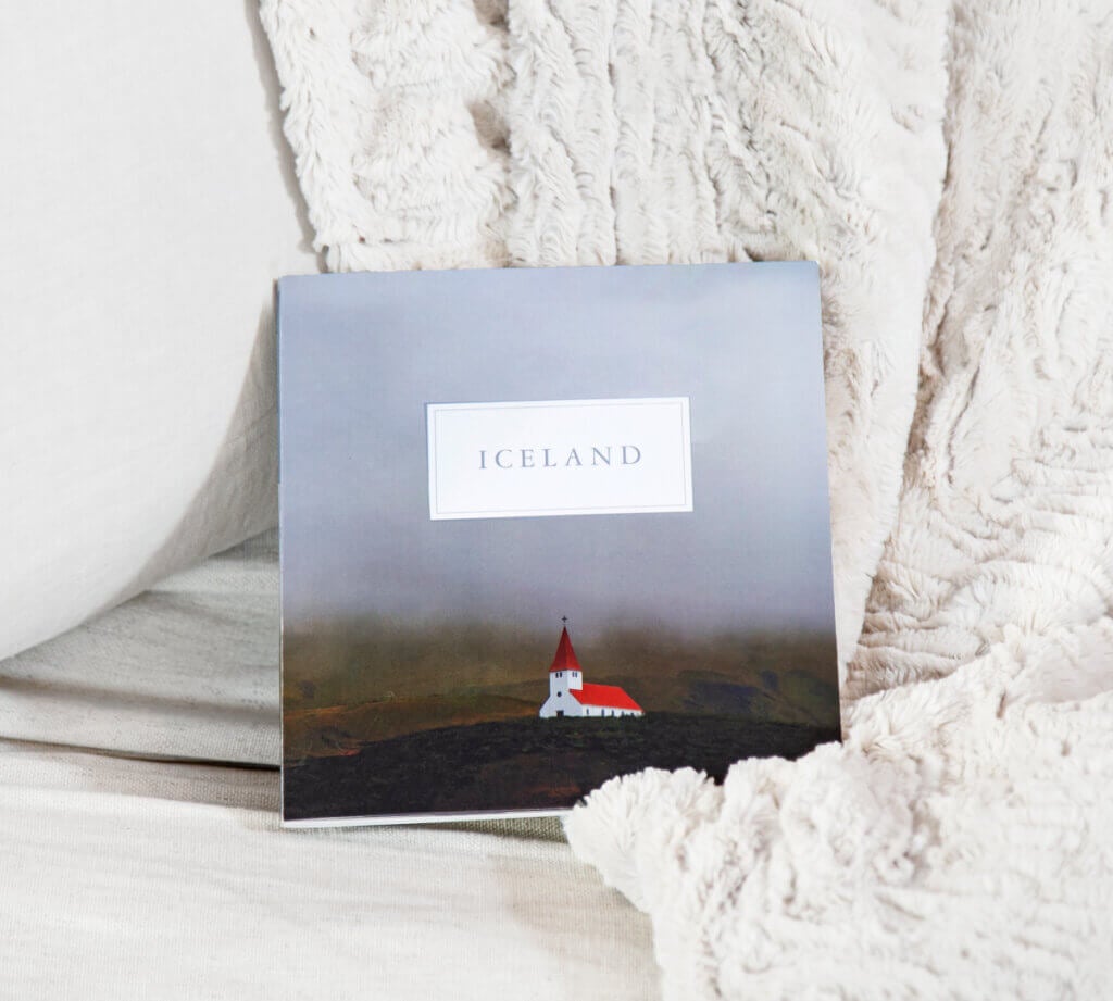 A mini photo book titled ICELAND features a photo of a church.