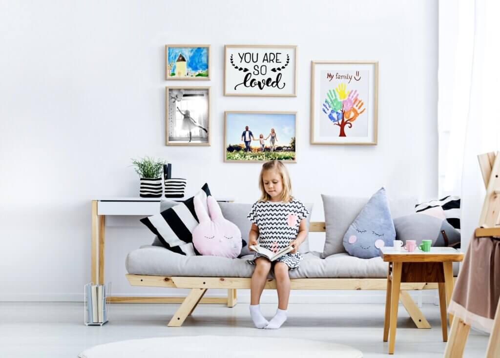 Child's artwork and family photos turned into a personalized photo gallery for children's room decor.