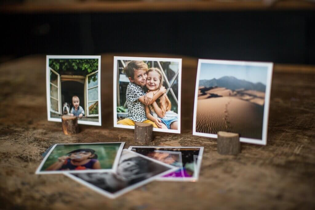 Photo prints stand in small wooden photo stands in this frame-free way to use photo prints.