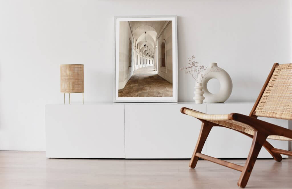 Beige-toned photograph of stone structure framed and displayed in Scandinavian home aesthetic.
