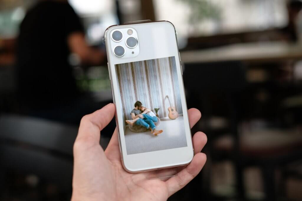 A photo print is displayed through a clear phone case in this frame-free way to use photo prints.