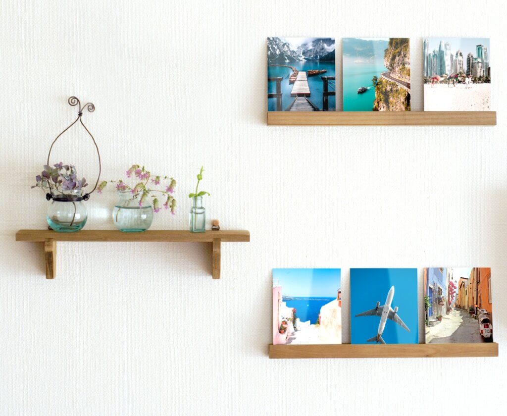 Photo prints are displayed on picture ledge in this frame-free way to use photo prints.