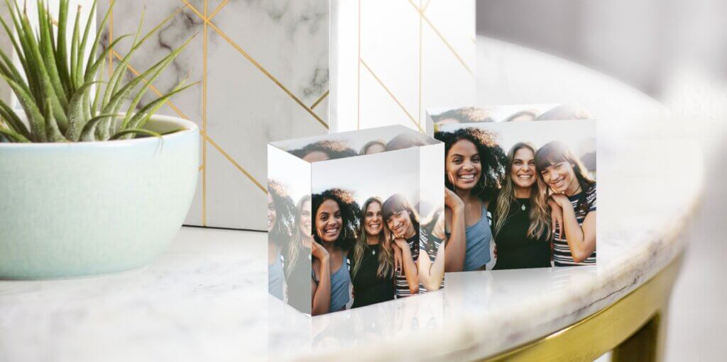 Custom acrylic prints of a group of friends decorates an end table.