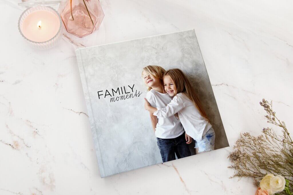 A family photo album sits on a counter top.