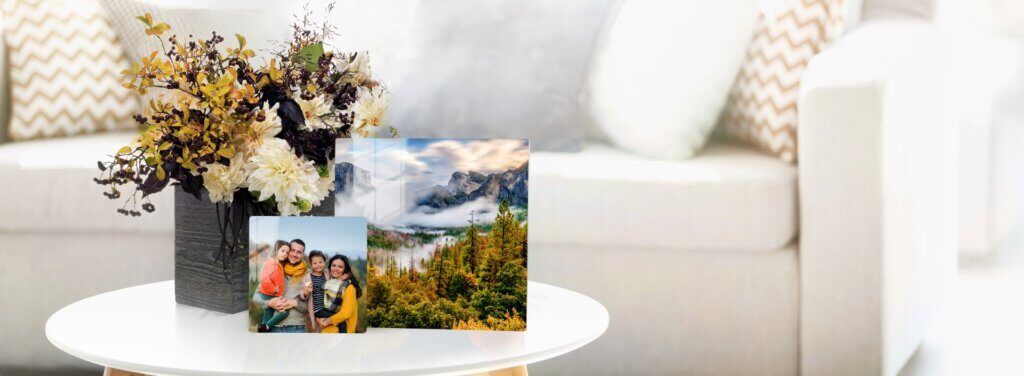 Two photos on metal decorate a coffee table with elegance.