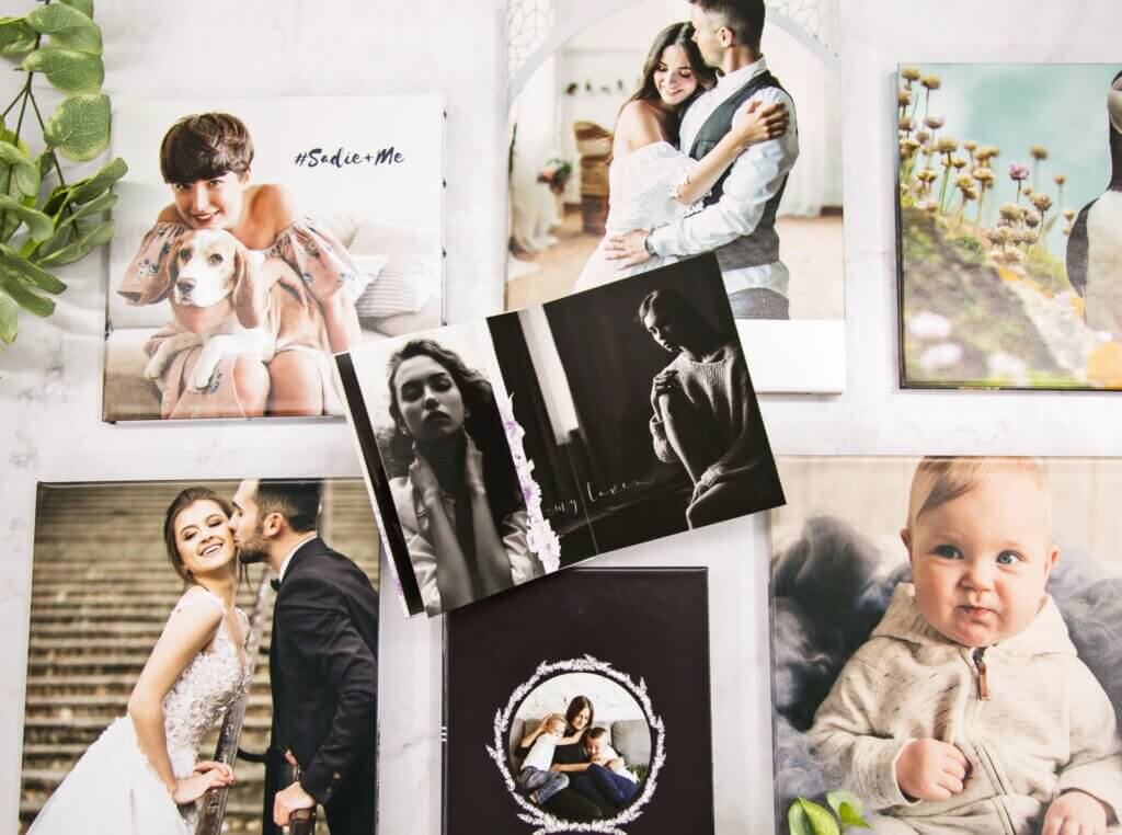 Range of DIY photo books sprawled on table top.