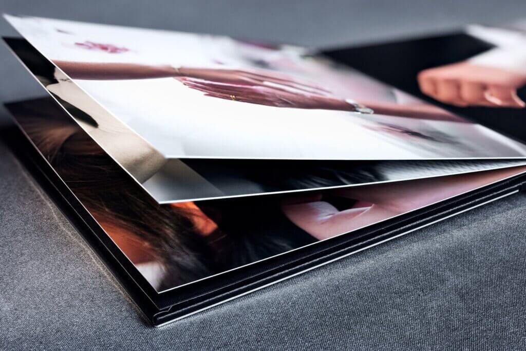 The thick pages of a custom photo album photographed up close.